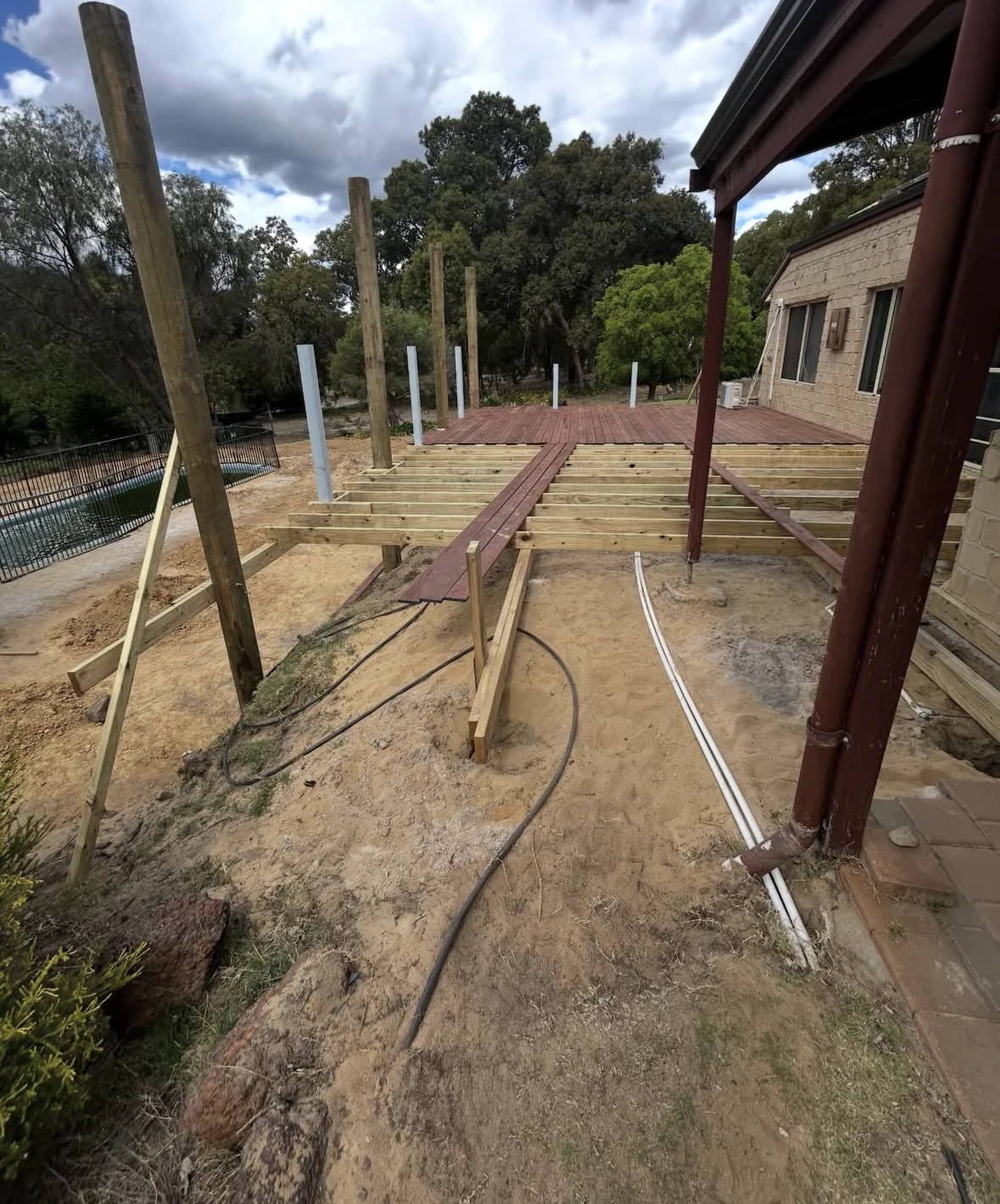 Partially laid decking shows the timber joists underneath